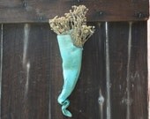 Large acqua wall pocket with sun shining through