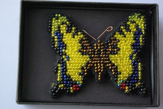 Swallowtail beaded butterfly brooch.