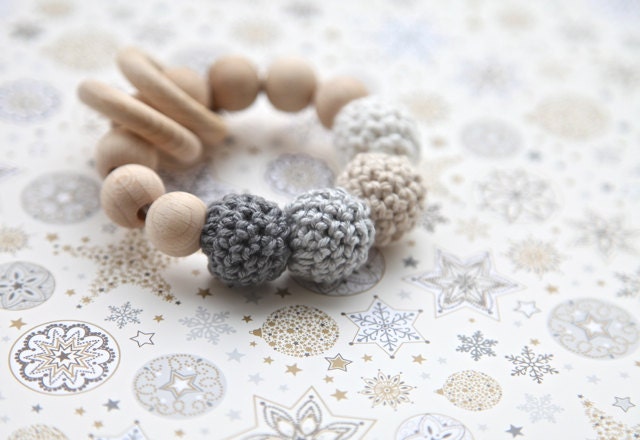 Neutral shades of grey and beige. Grey, beige, white teething ring toy with crochet wooden beads. Rattle for baby.
