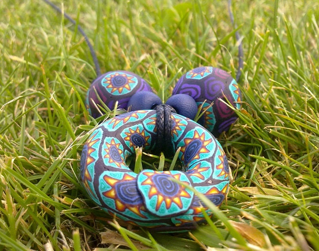 Hand made millefiori donut pendant with handmade beads on adjustable thong, tribal sunflower design with spirals