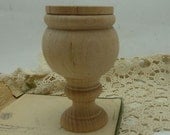 small  ready to decorate wooden urn  holds about 1/3 dry )cup It is 4 inches tall by 2 /12 inches wide  the bowl is 2 /14 tall by 2 /12 wide