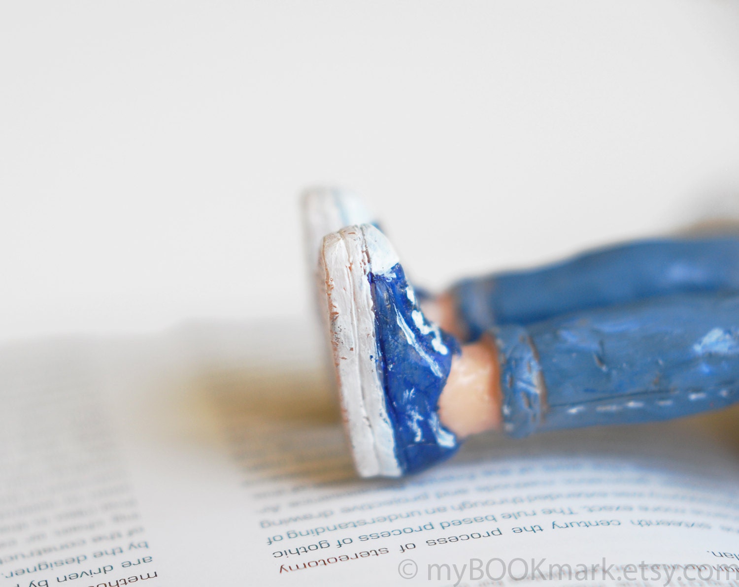 Legs in the book. Navy blue sneakers and blue jeans bookmark .Girly legs. Funny children gift, for her, him, kids, all, teacher.