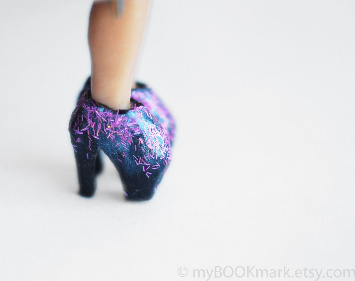 Alexander McQueen legendary shoes as a bookmark. Lady gaga legs in the book. Purple glitter. Elegant high fashion gift for her.