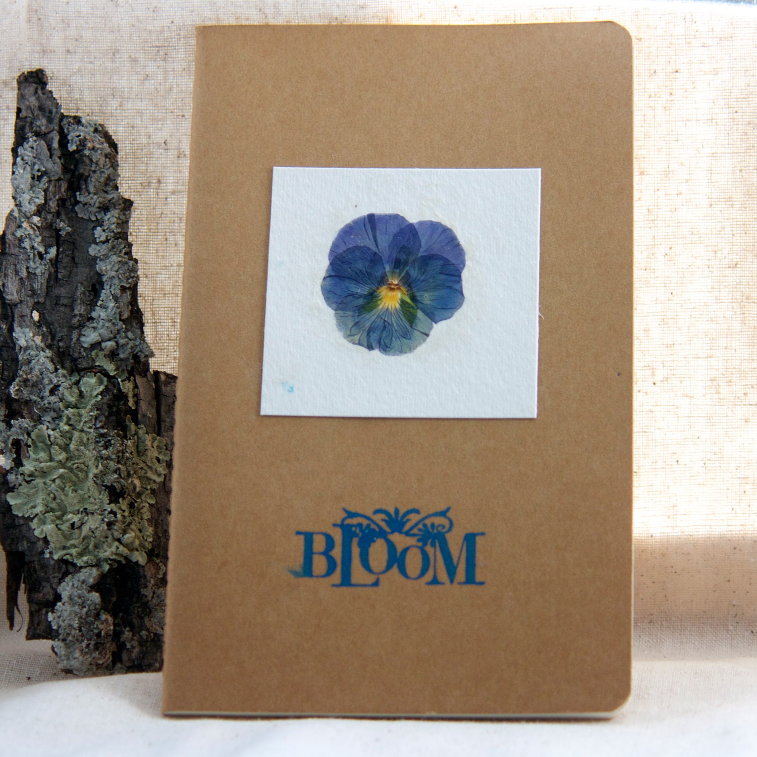 moleskine journal. botanical pressed violet pansy kraft paper. notebook library nature field guide. hello