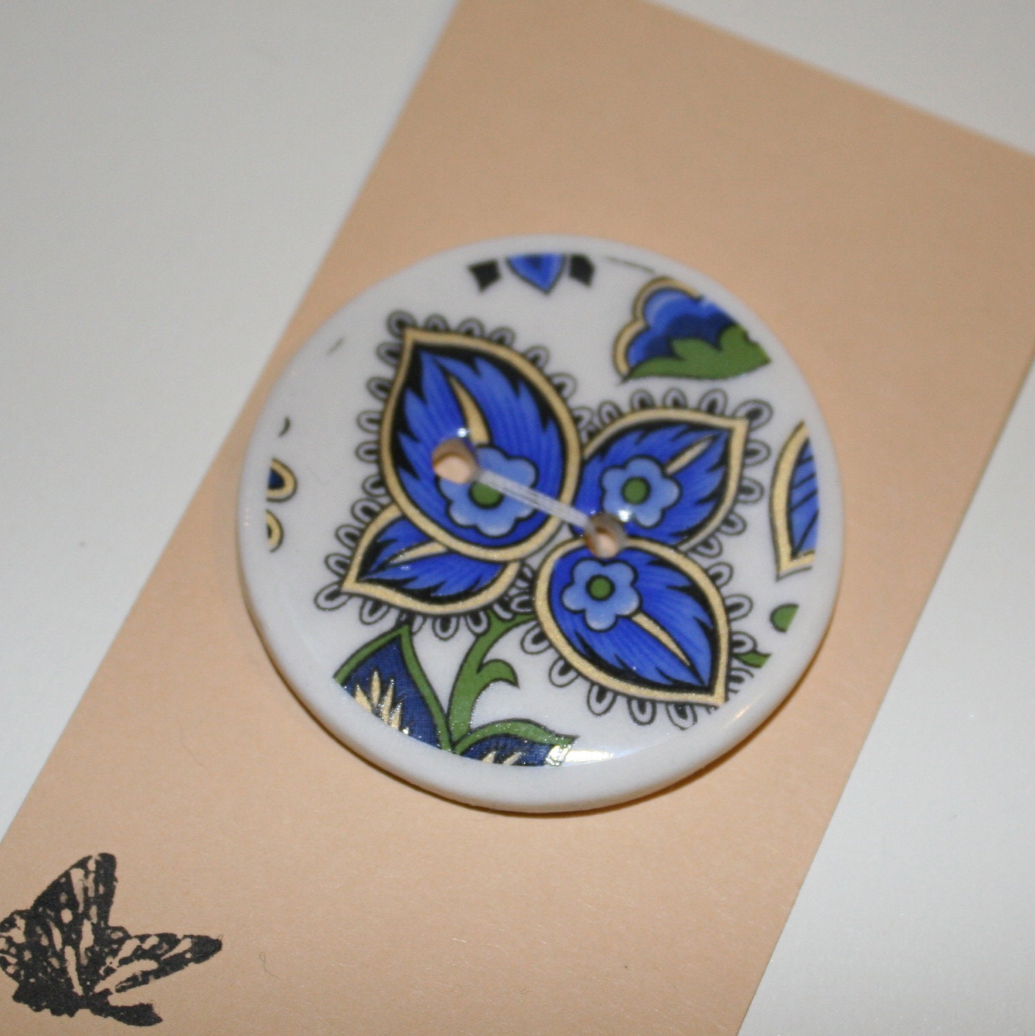 Button, porcelain white ceramic, with blue flower paisley design