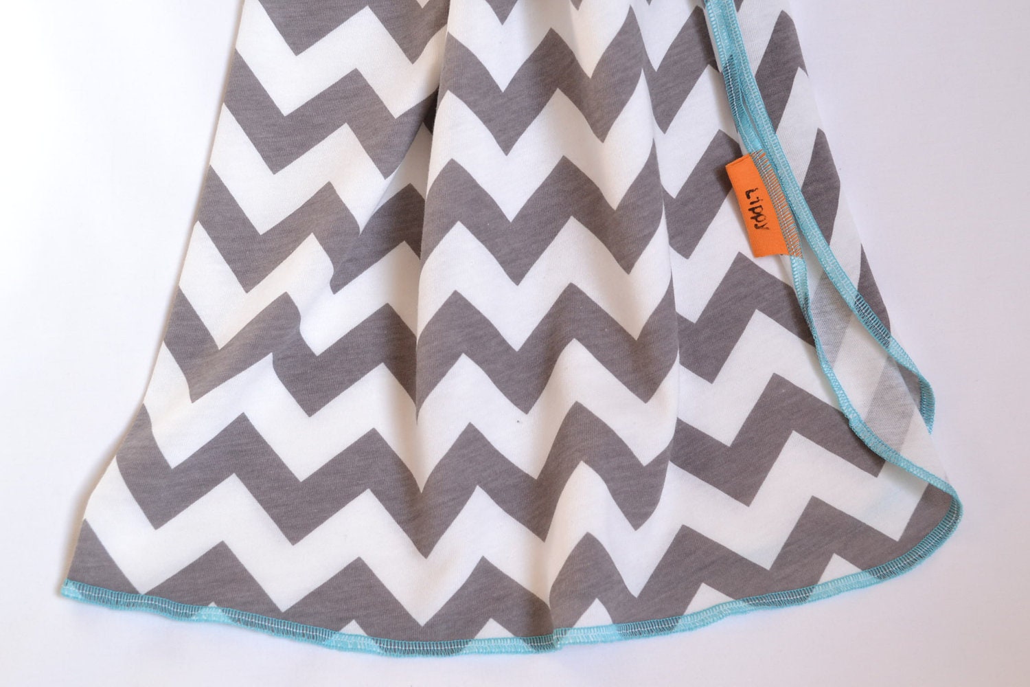 Chevron baby blanket. Blanket size: Size 31 by 40 inches. Colors- gray and white with blue edging.