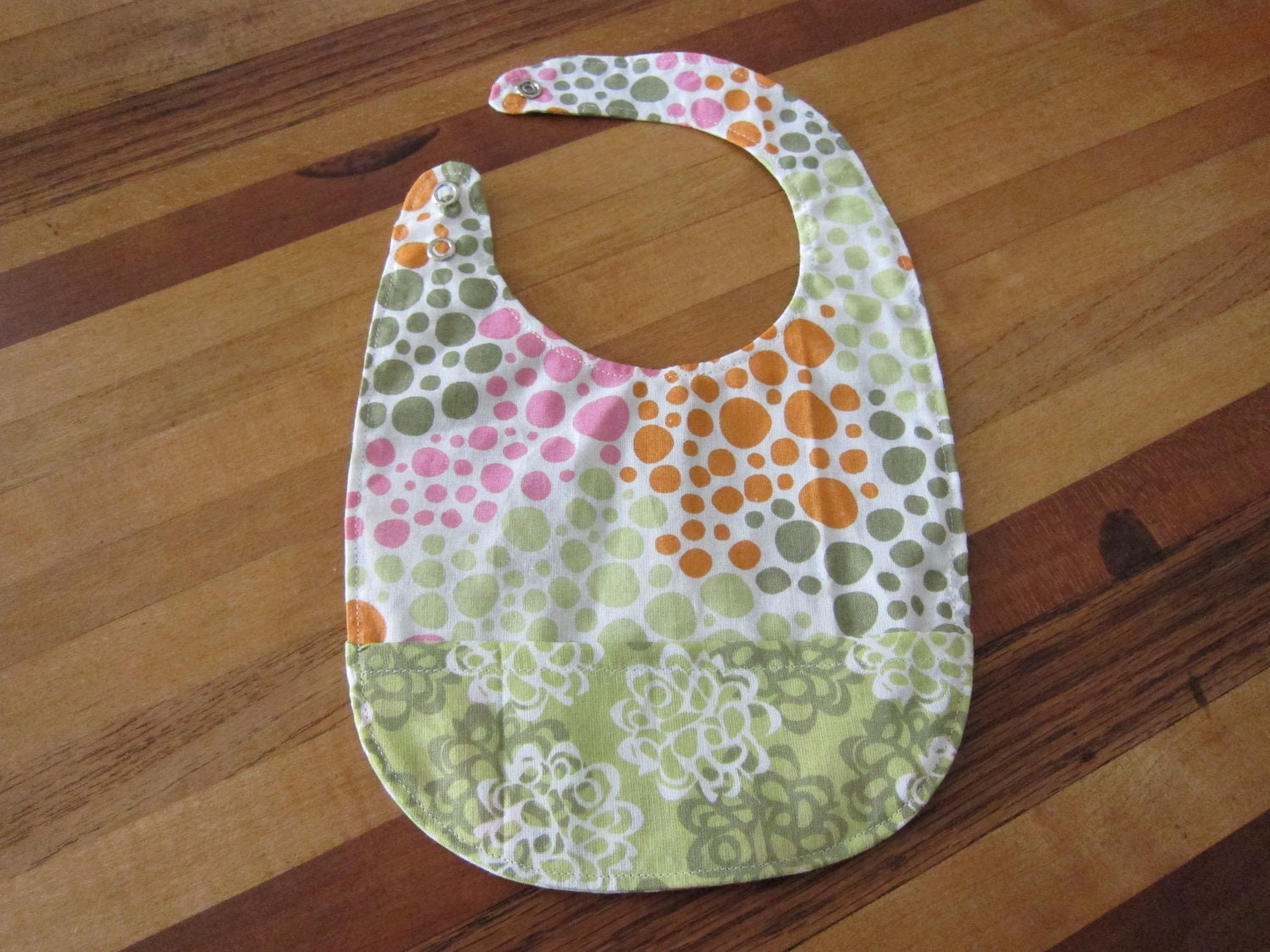Reversible and Adjustible Bib with Pocket in Green, Orange, and Pink Floral and Polka Dots