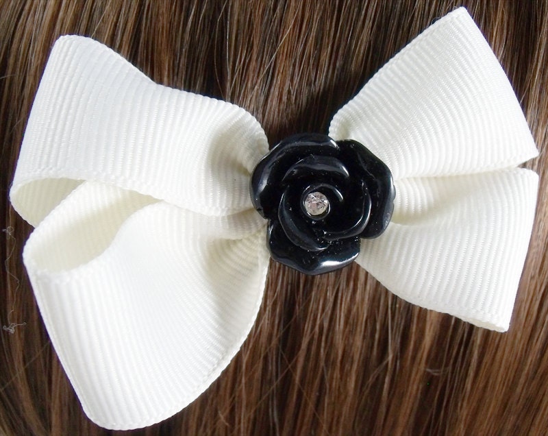 Cream hair bow with black rose and a rhinestone center