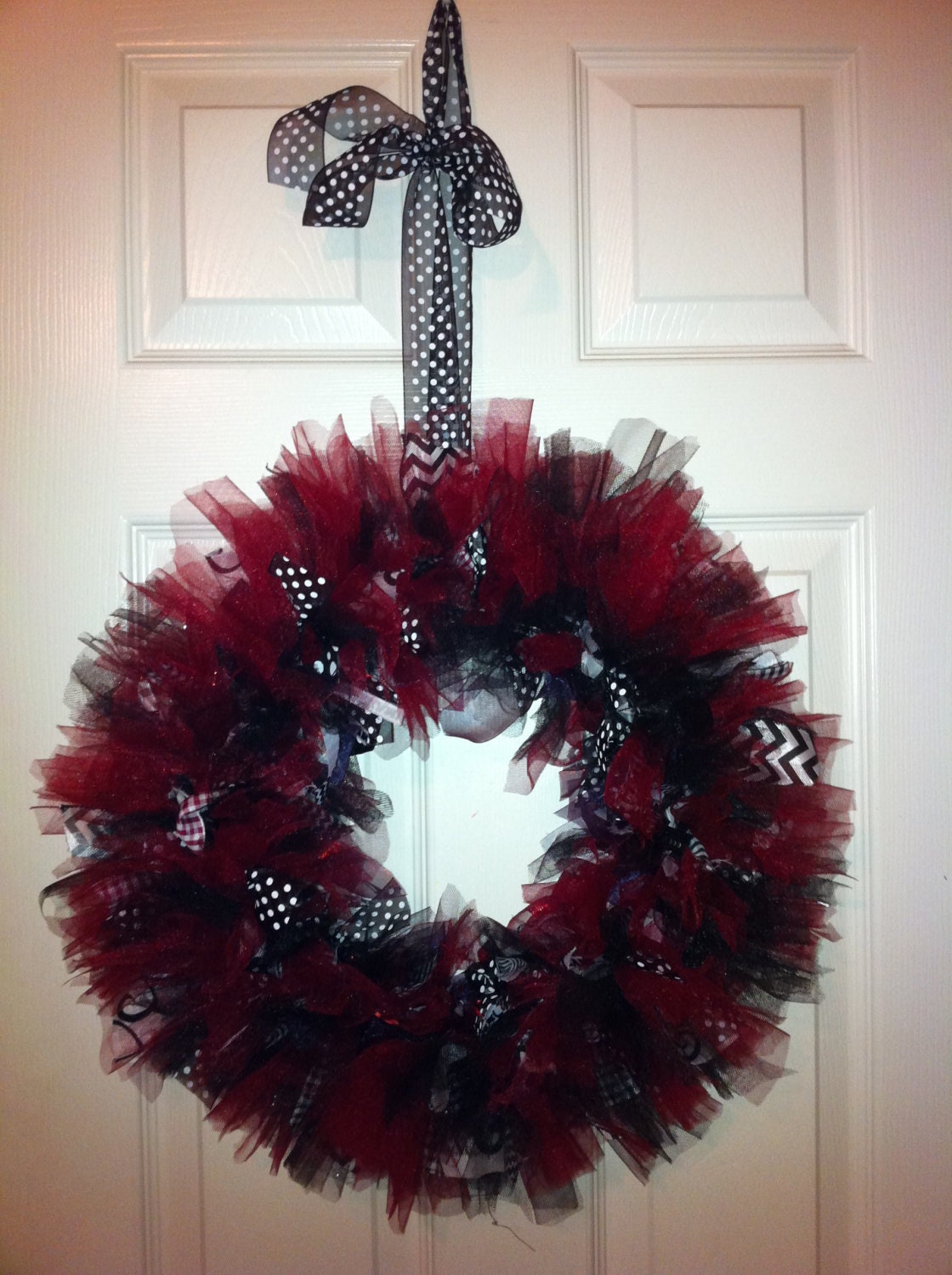 Garnet and Black Ribbon Wreath. Measures 17 inches wide and 17 inches Tall. Lots of tulle and ribbon.