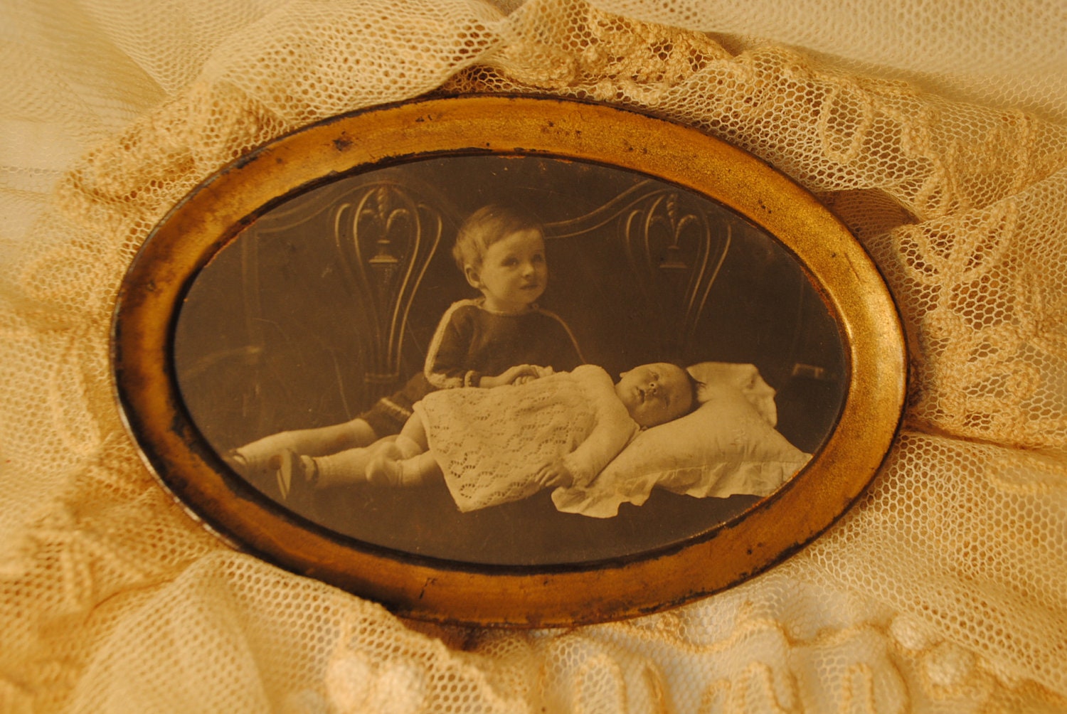 post mortum photo of baby with distraught boy. or just Edwardian Photo of a boy with sibling. Black and White antique photo Made in England
