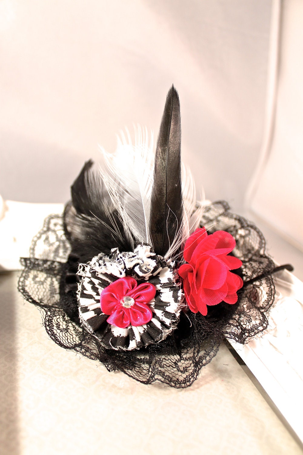 Whimsical top hat with zebra and hot pink flowers with feathers and lace and matching zebra bow footless sandals.