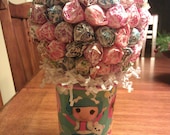 Lalaloopsy dum dum centerpiece... Cup features Bea spell alot, Crumbs sugar cookie, Jewel sparkles and Mittens fluff and stuff...