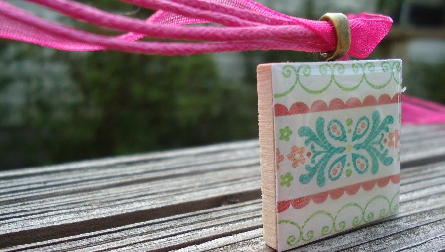 Patterned Necklace with Pretty Flowers Pastel Colors on Wood Tile