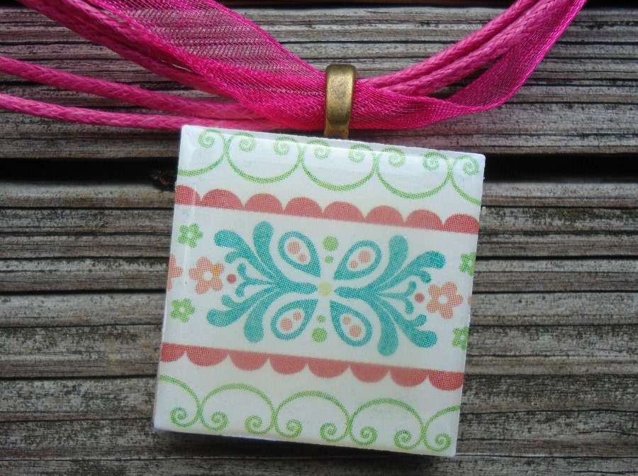 Patterned Necklace with Pretty Flowers Pastel Colors on Wood Tile