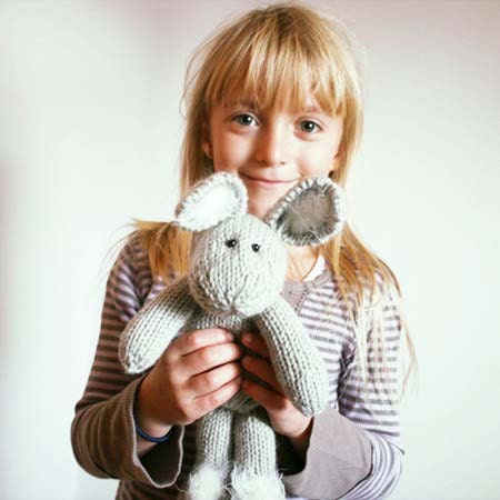 White and gray playfull bunny, light and cuddly knitted soft toy from fine blend yarn with furry mohair ears and paws