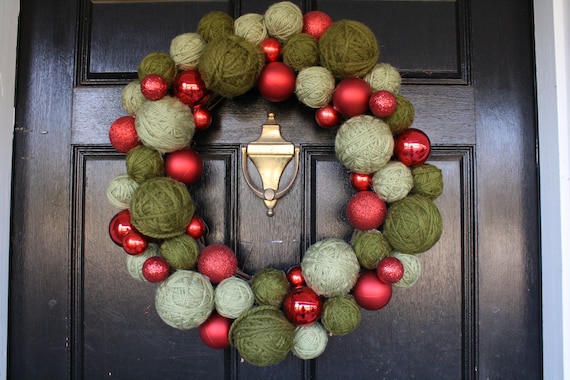 Christmas Wreath Red Christmas balls and green yarn balls on a grapevine wreath