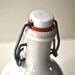 Vintage French Stoneware Covinor Red Wine Vinegar Bottle in white and Red colors with its a porcelain stopper