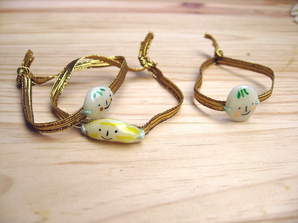 Golden Bracelet with elastic trim. Fruits. Porcelain charms. Pineapple, Strawberry and Banana.