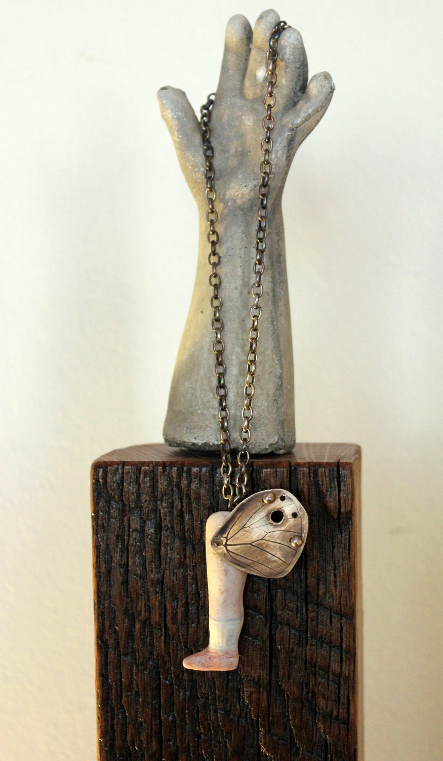 Butterfly Wing Embossed into Brass Metal with Antique Porcelain Doll Leg Icarus