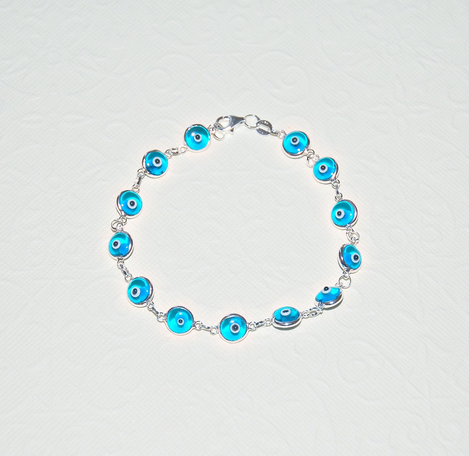 Evil eye bracelet - linked sterling silver bezel set evil eye charms in turquoise glass - modern talisman jewelry - constantina