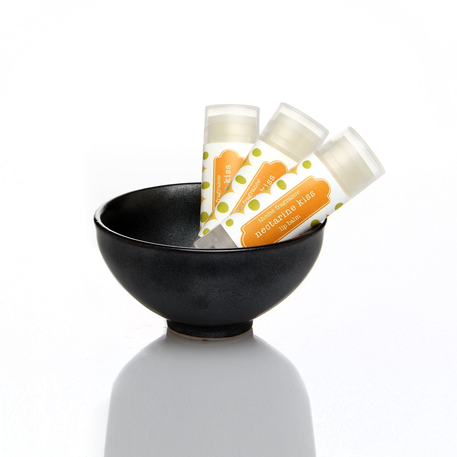 Nectarine Kiss glossy lip balm tube.  fruity nectarine flavor. Theme Fragrance