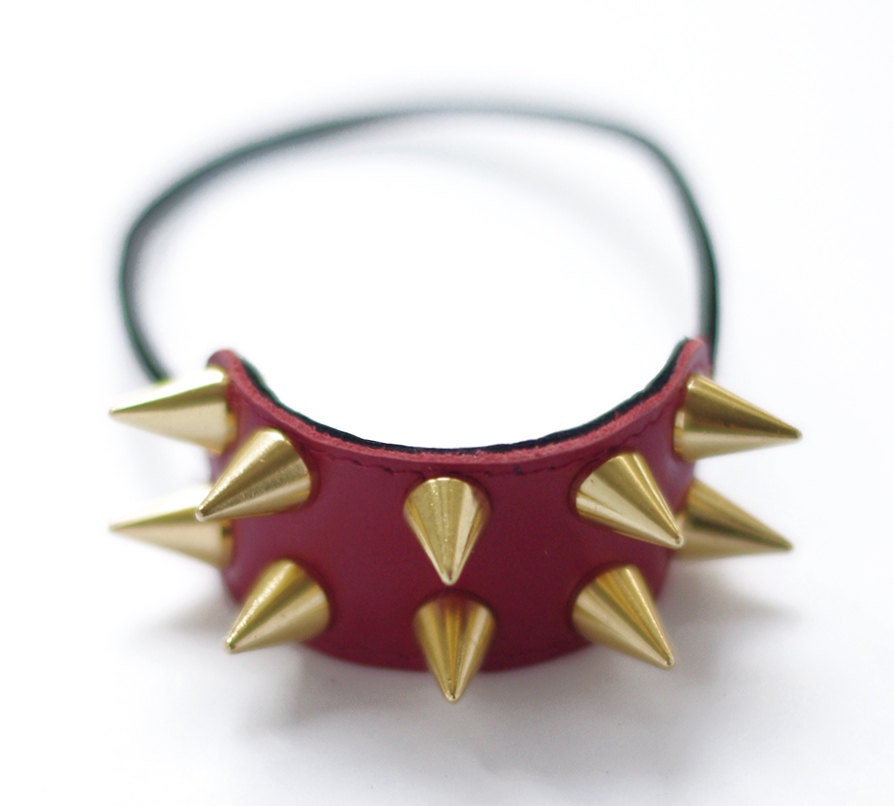 Handmade red leather hair elastic with golden or silver mini cone spikes.