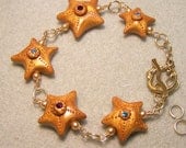 Golden jeweled Starfish bracelet with mermaid clasp