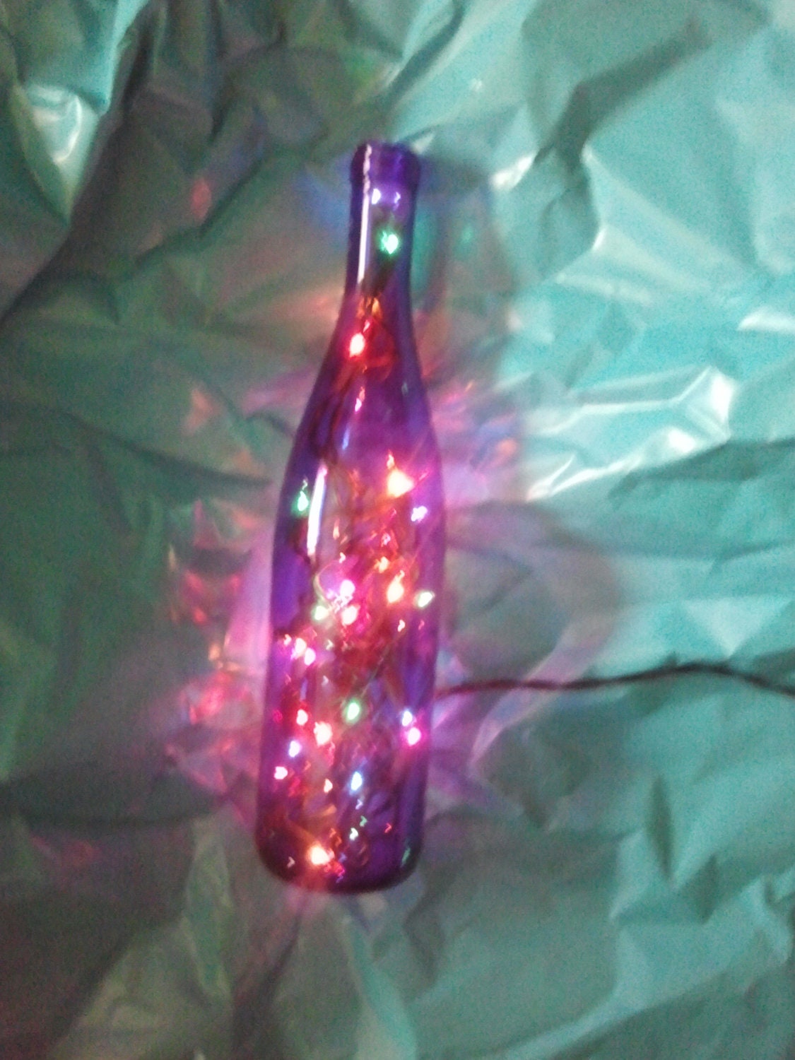 Blue wine bottle luminary with rainbow lights