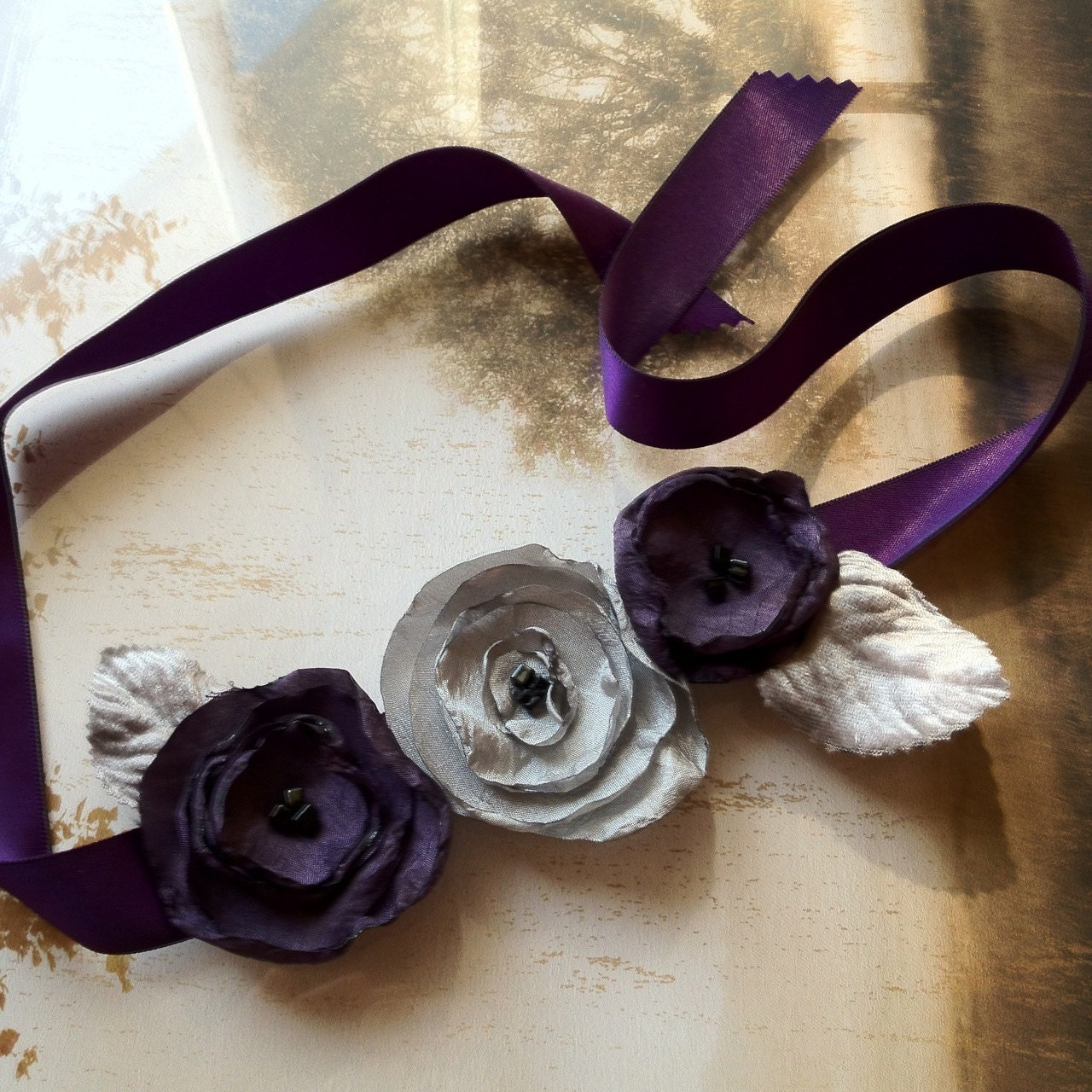 Eggplant purple and silver gray singed flower hair clips on a satin headband ribbon. Fall weddings bridesmaid.