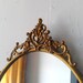 Antique Oval Mirror in Ornate Brass Frame 19 by 12 inches