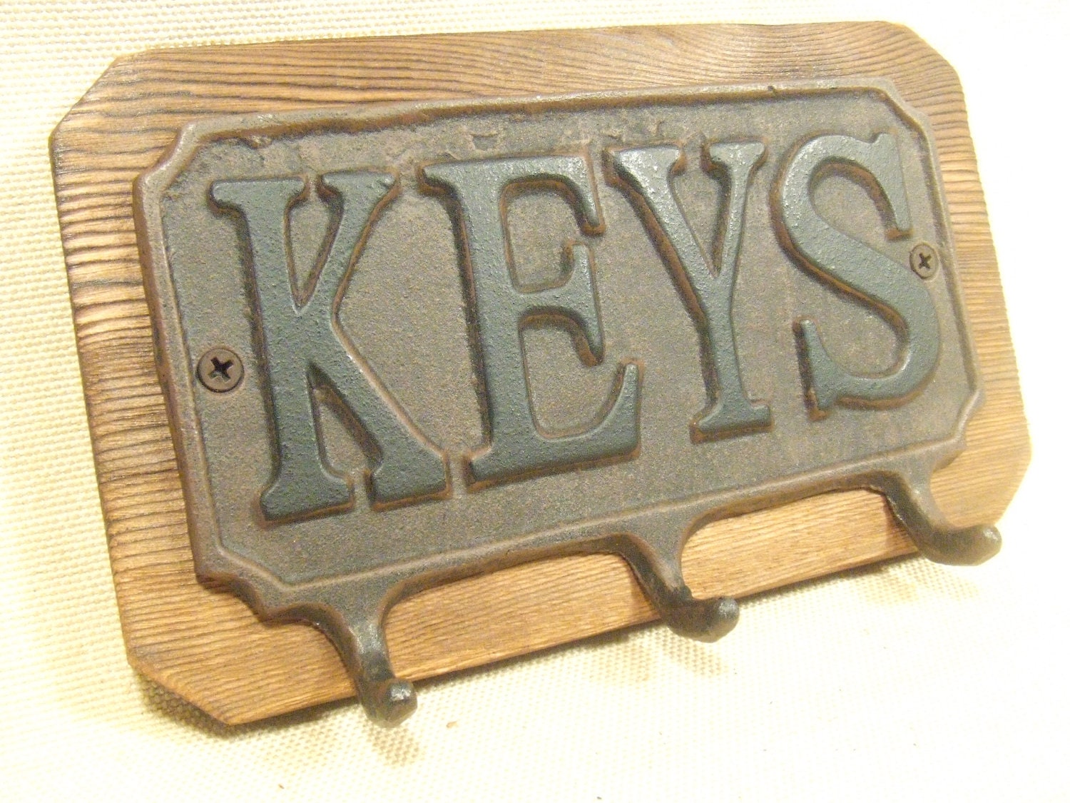 Rustic Cast Iron Key rack  -- lodge cabin decor -- rich patina on cast iron hooks and western cedar