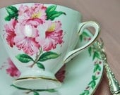 Beautiful GLADSTONE Tea Cup and Saucer "Laurel Time", Hibiscus, Pink, Green, Footed, England