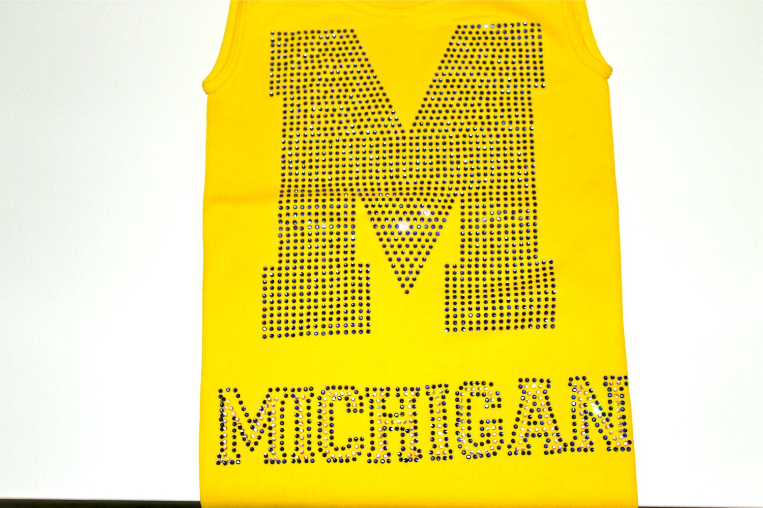 Sugar lips tank top with a royal blue "M" across the front.