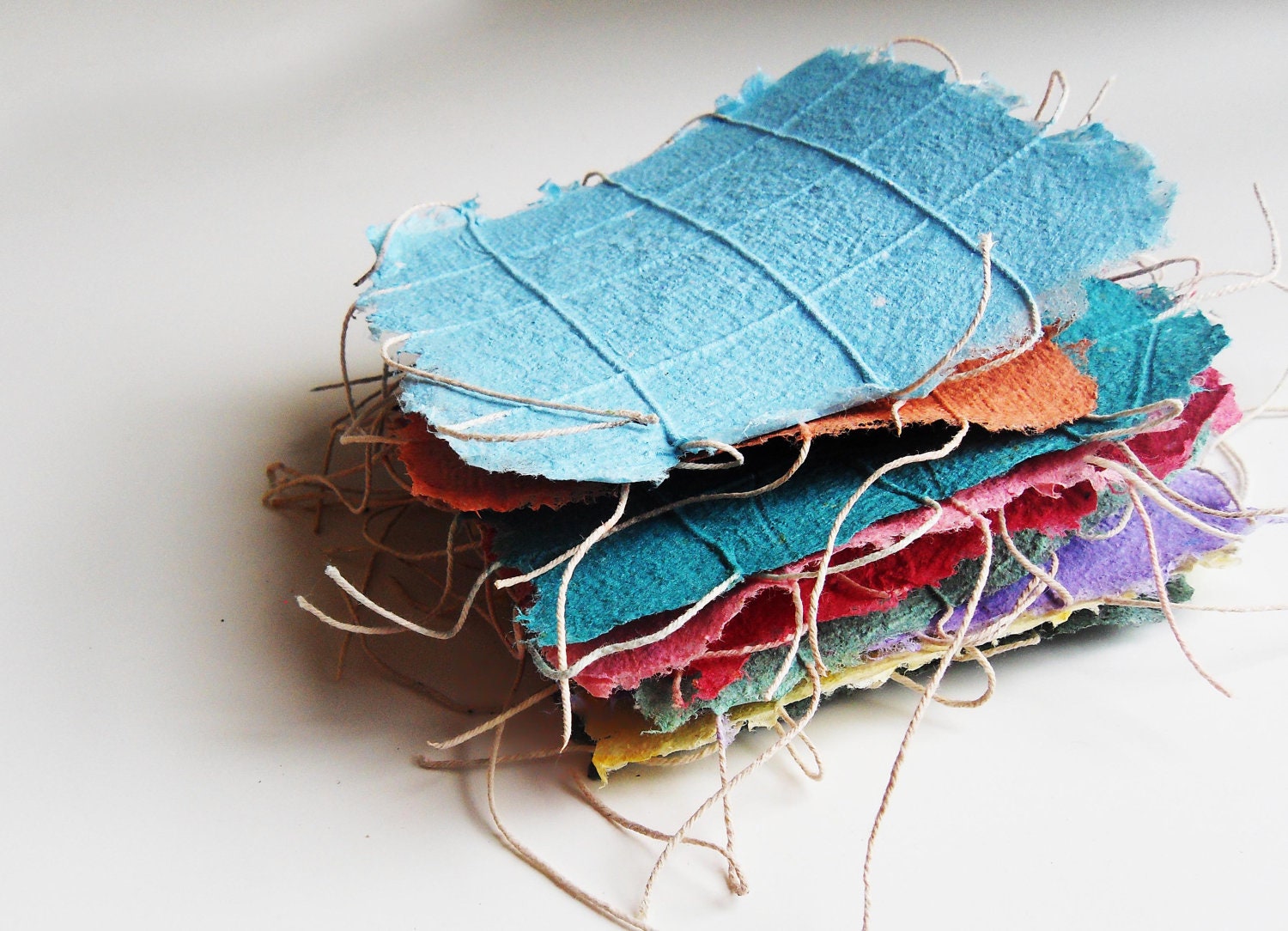 Unique handmade paper with string. Highly textural for books arts, paper quilts, collages, bookbinding. 5x5 inch square sheets. set of 8