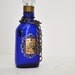 Cobalt blue medicine bottle, a steampunk theme with vintage items.