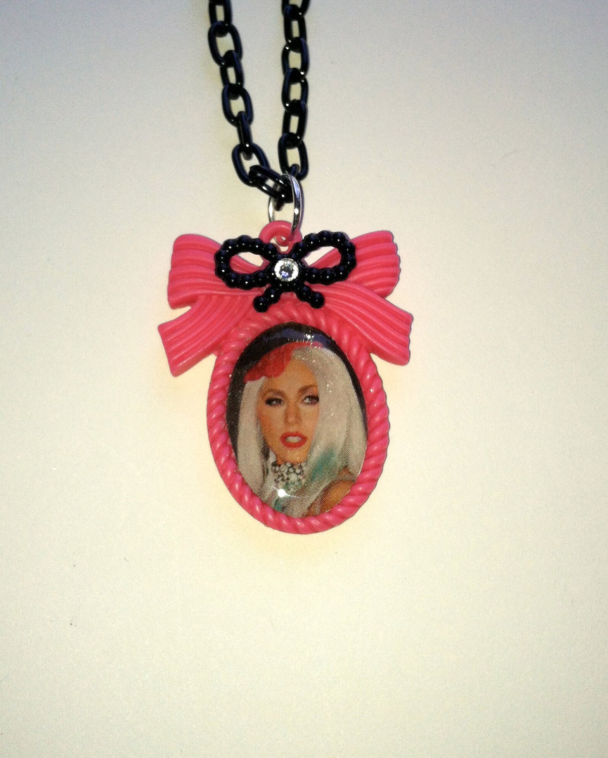 Lady Gaga Necklace on a hot pink bow cameo, black aluminum chain, black bow with crystal. Poker face, born this way, bad romance, telephone