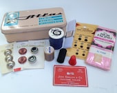 Vintage Atlas tin with small destash lot of vintage sewing supplies - buttons, thread, needles, hem facing