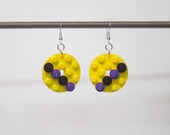 Yellow disk earrings with purple and black pieces and silver plated ear wires