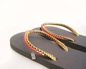Decorated flip flops. Flip flops in grey. Red rhinestone, neon strings.