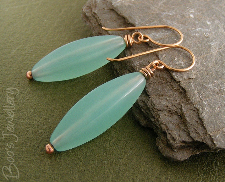 Polished bronze earrings with aquamarine coloured torpedo beads