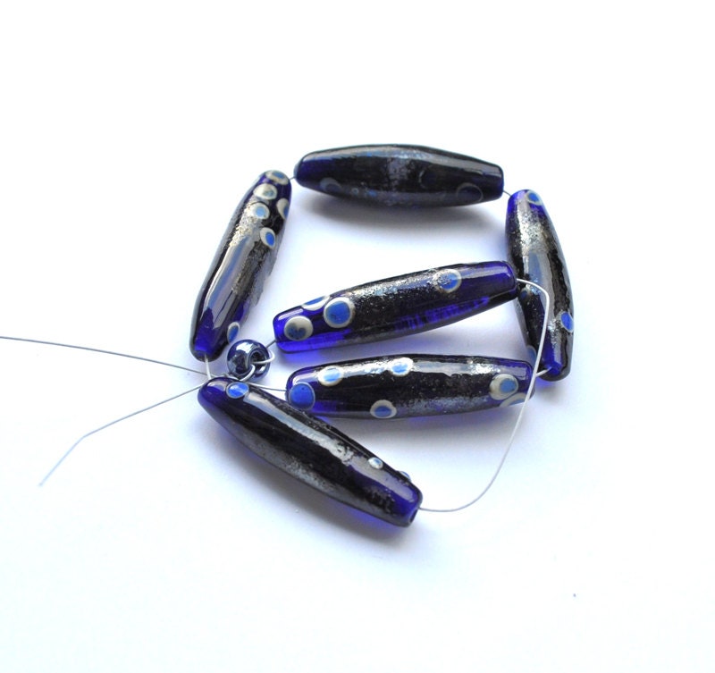 Set of long dark blue/dark golden lampwork beads