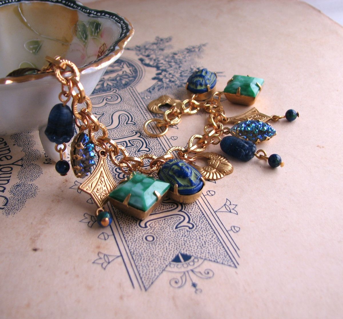 Egyptian Revival charm bracelet with vintage lapis blue and jade art glass
