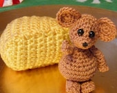 Crocheted miniature mouse with cheese wedge