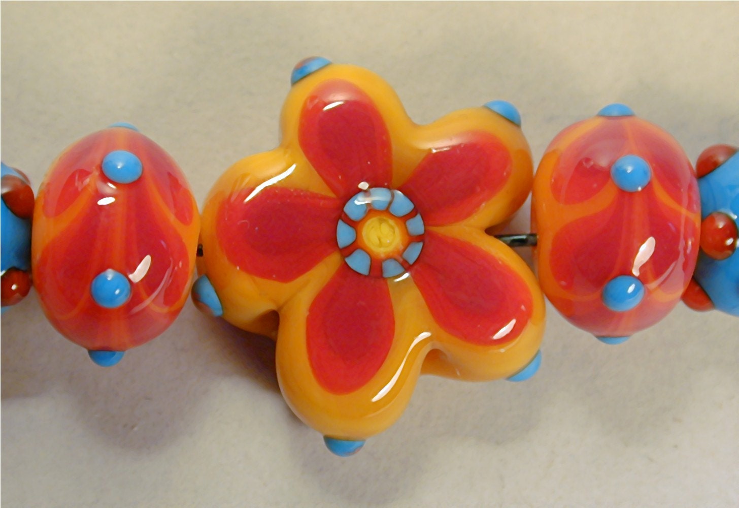 Handmade Lampwork Glass Bead set of 7, ooak, by Patti Cahill, sra -- Swimsuit color scheme with floral focal