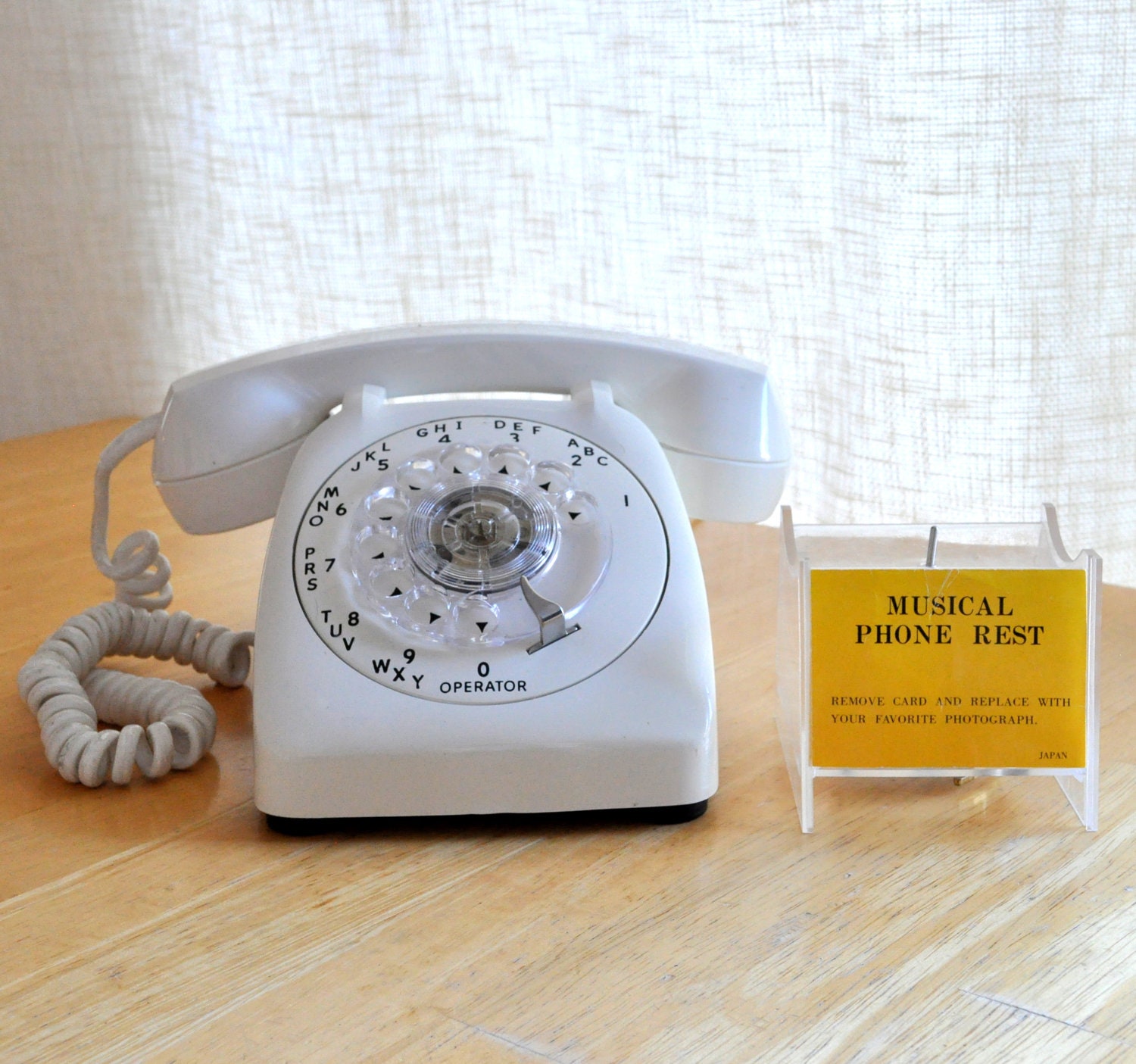 vintage white rotary AE 80 phone with "on hold" musical phone rest