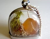 Miniature terrarium dome window locket. Clear windows show semiprecious aventurine stone with moss. Medium length