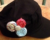 Black distressed conductor style hat with red and bluee. No bad hair day here