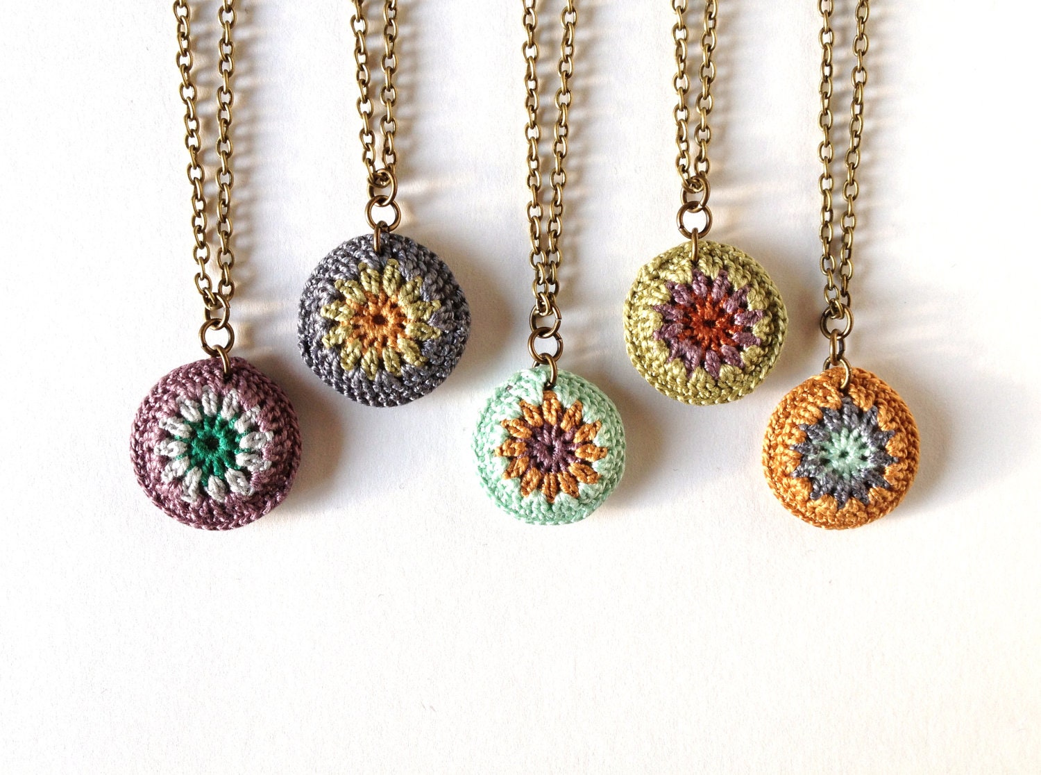 Mini Crocheted Sunburst Pendant: Kelly Green, Gold, Amethyst, Rust, and Mint.