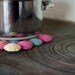 Eco cotton and wood trivet in pastels. Crocheted circles in pink, peach, yellow and blue. Eco friendly.