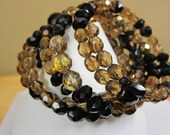 Bracelet - Multi Strand with Black and Topaz colored Crystal Beads on Memory Wire